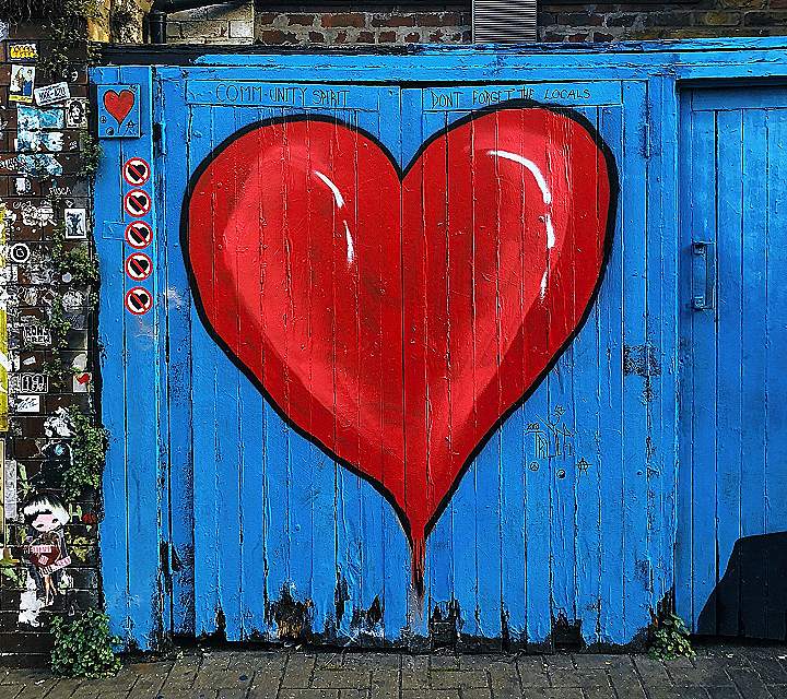 blue wooden gate with a red heart painted on it