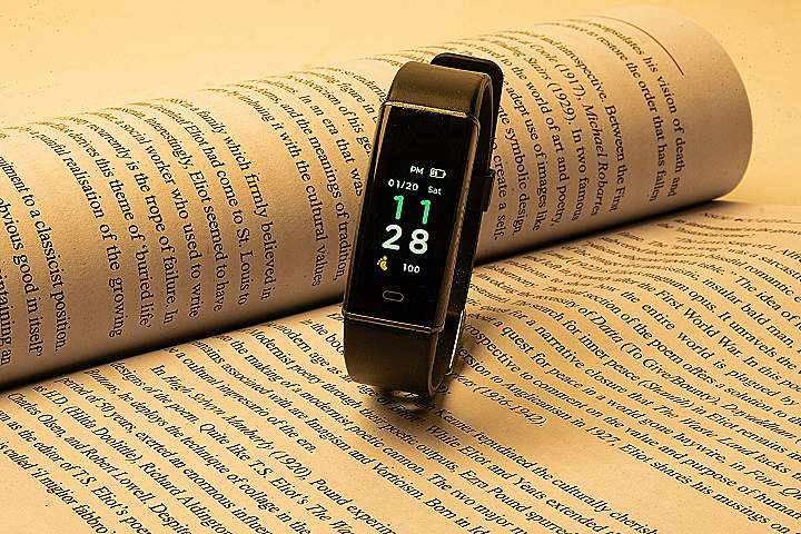 a smart watch sitting on top of an open book