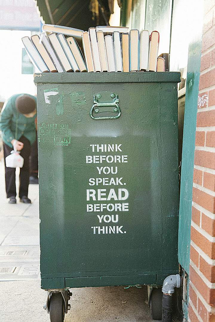 books over green trolley bin