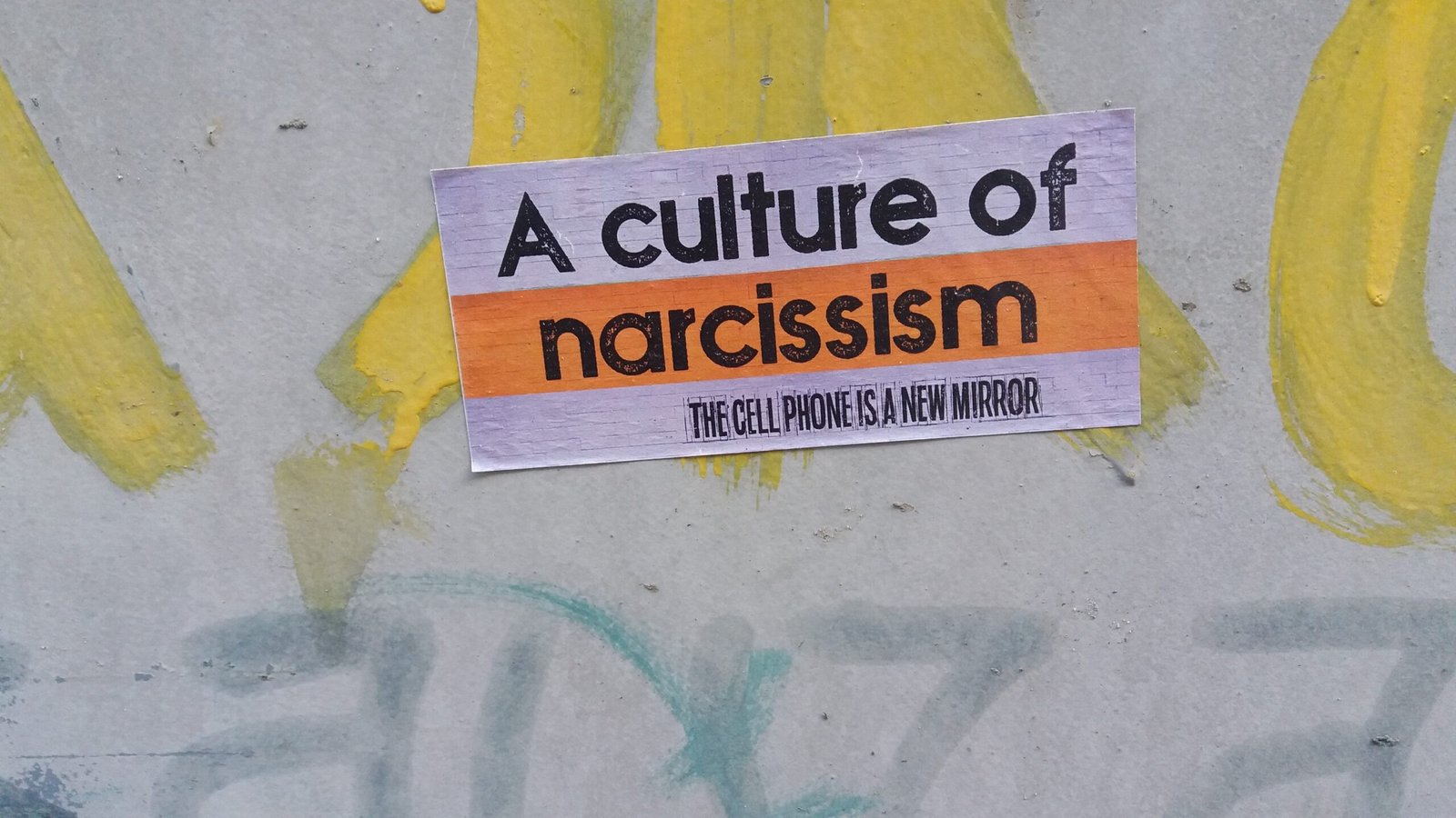 a sign on the side of a wall that says a culture of narciss