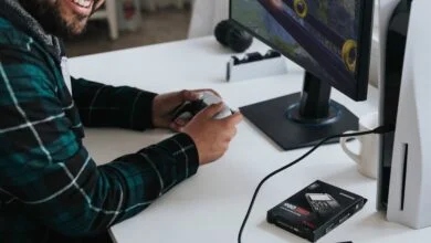 a man wearing headphones and sitting at a desk with a computer