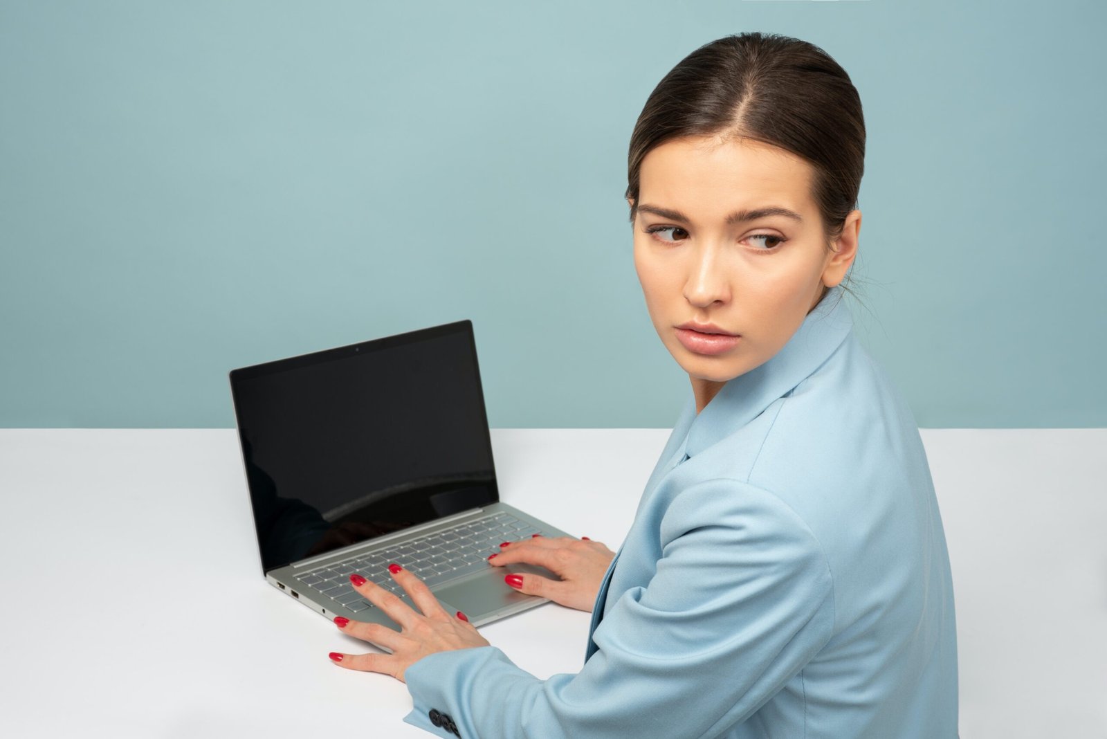 woman using laptop and looking side