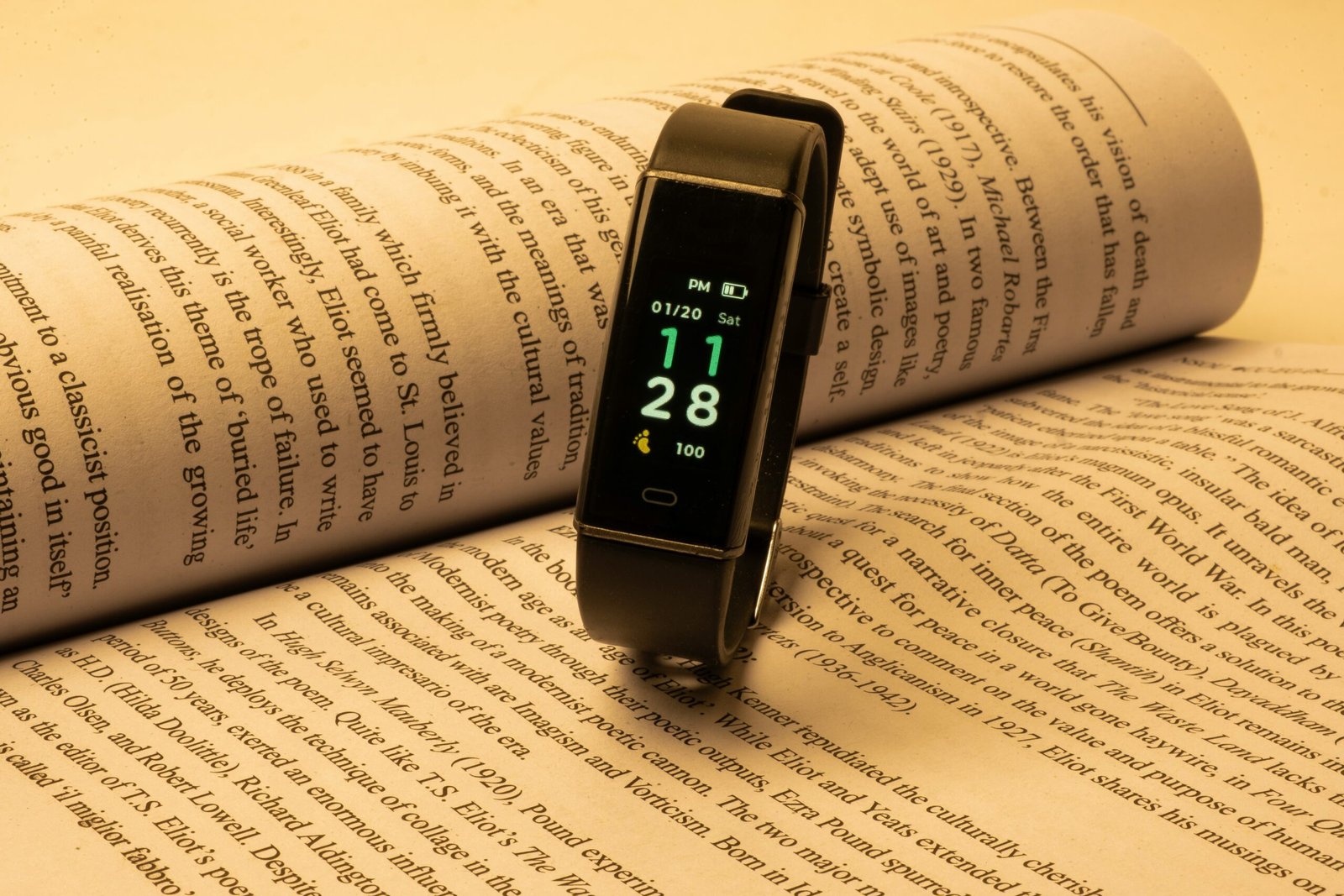 a smart watch sitting on top of an open book